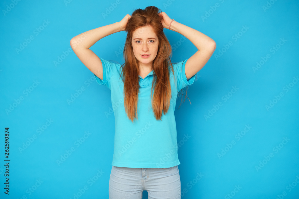 Happy and cute girl standing on blue background. Happy and cute girl standing on blue background.