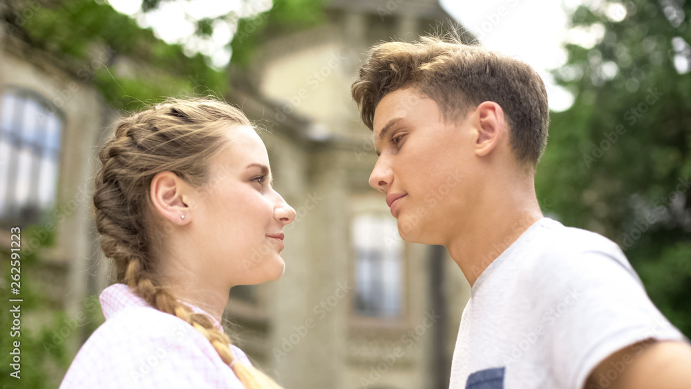 Teenagers looking at each other, first relations, romantic date, feeling love Teenagers looking at each other, first relations, romantic date, feeling love