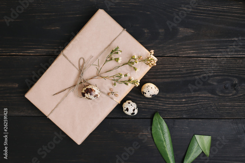  Rustic easter still life with quail eggs, dry willow branches on dark background. Flat lay, top view