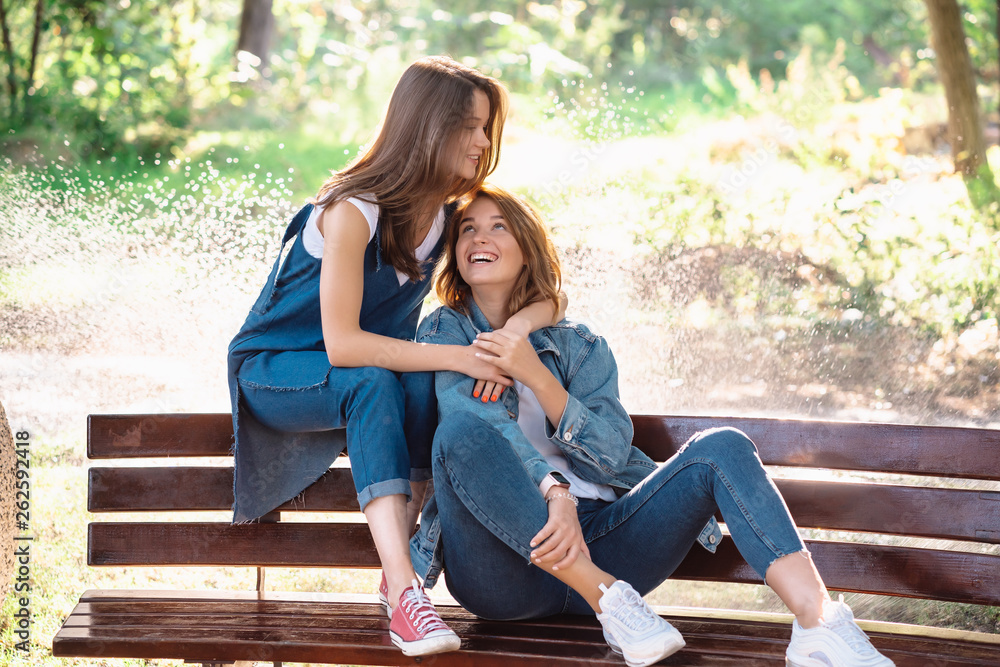 Two beautiful young woman resting on a bench Two beautiful young woman resting on a bench