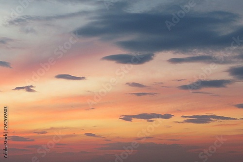 Beautiful pink orange sunset with dark clouds, natural background 