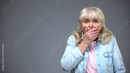 Senior female shocked with bad news, frightened elderly lady, negative emotions