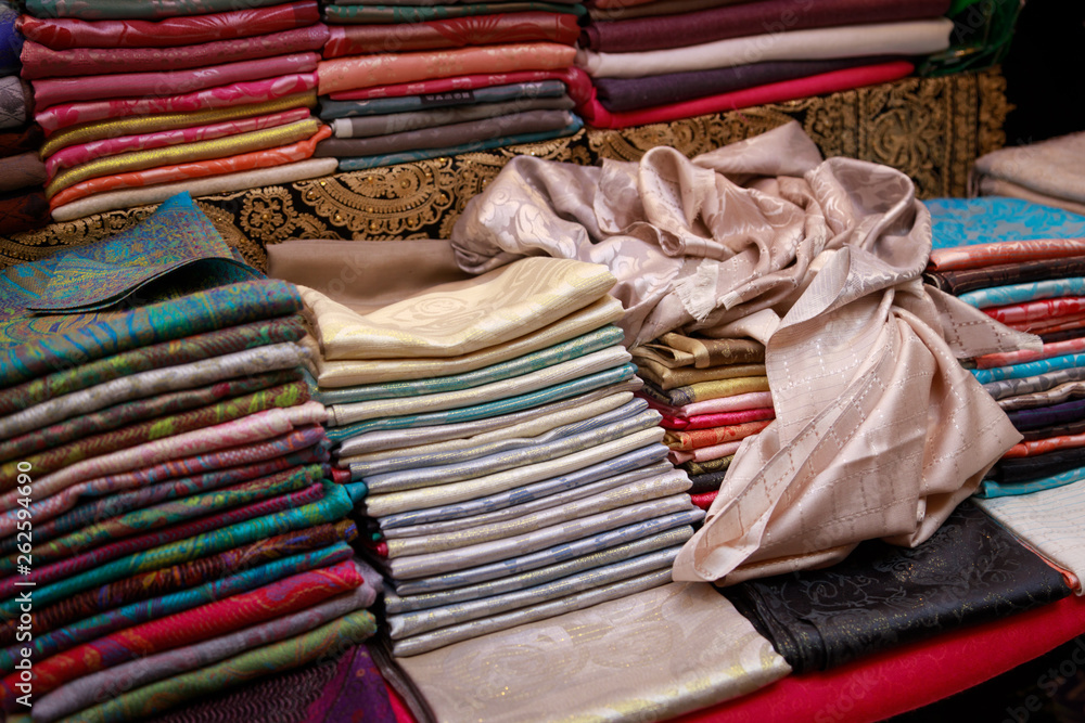 Thin beautiful handmade pashmina shawls lie on the counter Thin beautiful handmade pashmina shawls lie on the counter