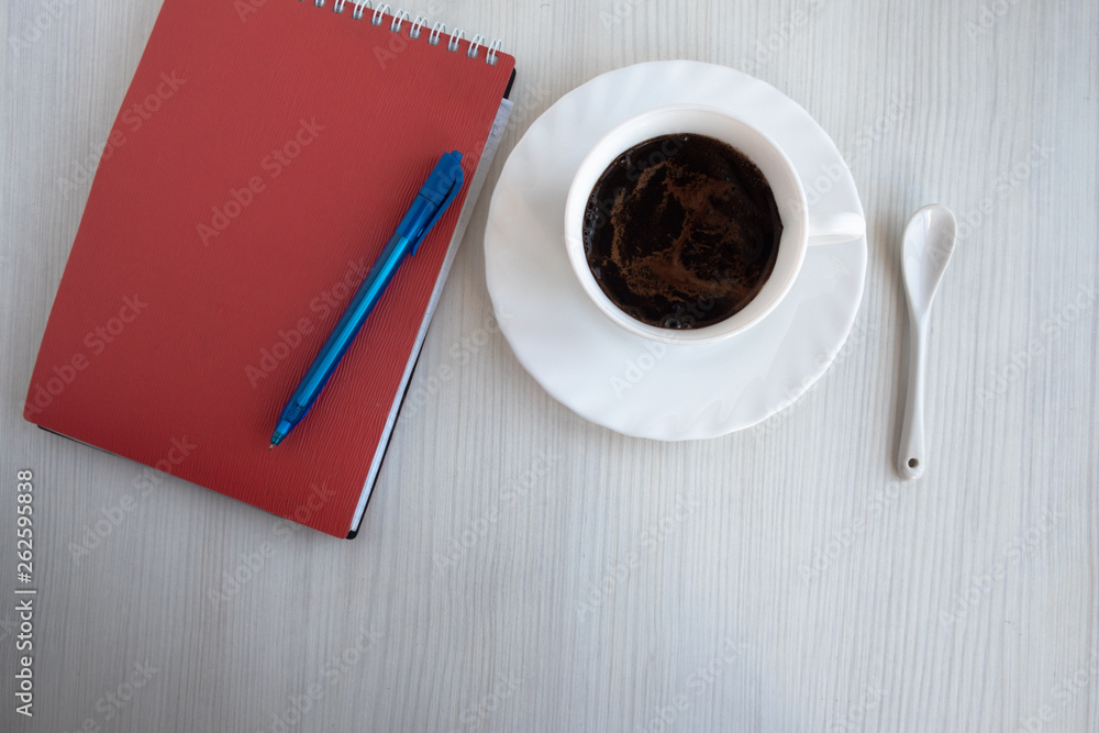notebook, pen and cup of coffee on white table notebook, pen and cup of coffee on white table