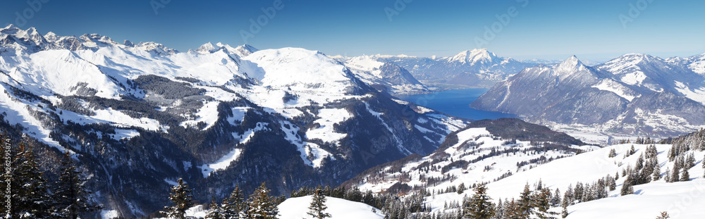 Obraz premium Beautiful winter landscape. People skiing in Hoch Ybrig ski resort, Switzerland, Europe.