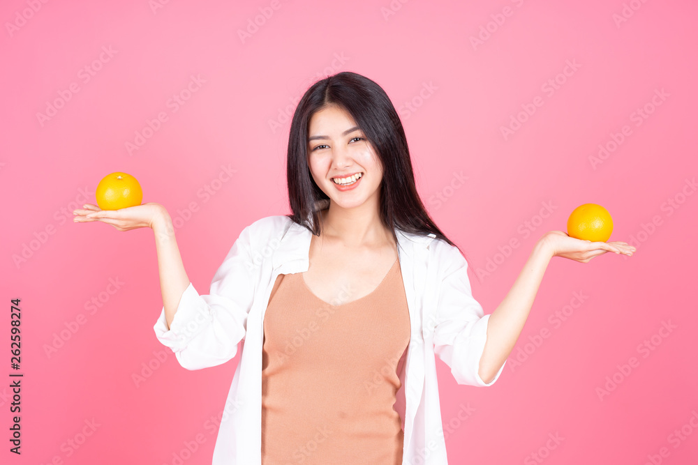 beauty woman Asian cute girl feel happy holdind orange fruit for good health on pink background - lifestyle beauty woman beauty woman Asian cute girl feel happy holdind orange fruit for good health on pink background - lifestyle beauty woman