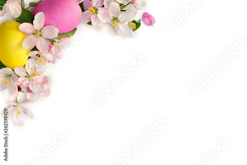 Fototapeta Naklejka Na Ścianę i Meble -  Easter decoration. Pink flowers apple tree and colored easter eggs on white background with space for text. Top view, flat lay