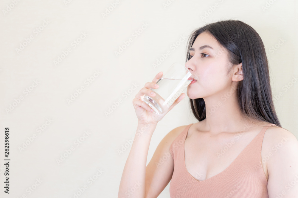 Beautiful beauty woman Asian cute girl feel happy drinking Clean drink water for good health in the morning , enjoying time in her home white bedroom background - lifestyle beauty woman concept Beautiful beauty woman Asian cute girl feel happy drinking Clean drink water for good health in the morning , enjoying time in her home white bedroom background - lifestyle beauty woman concept
