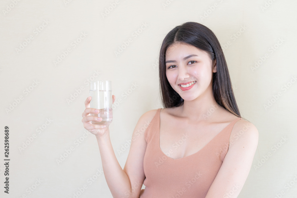 Beautiful beauty woman Asian cute girl feel happy drinking Clean drink water for good health in the morning , enjoying time in her home white bedroom background - lifestyle beauty woman concept Beautiful beauty woman Asian cute girl feel happy drinking Clean drink water for good health in the morning , enjoying time in her home white bedroom background - lifestyle beauty woman concept