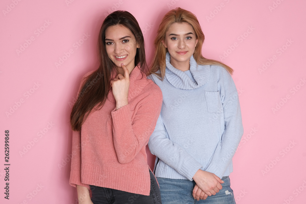 Two totally different looking sisters making funny faces at studio shoot. Two totally different looking sisters making funny faces at studio shoot.