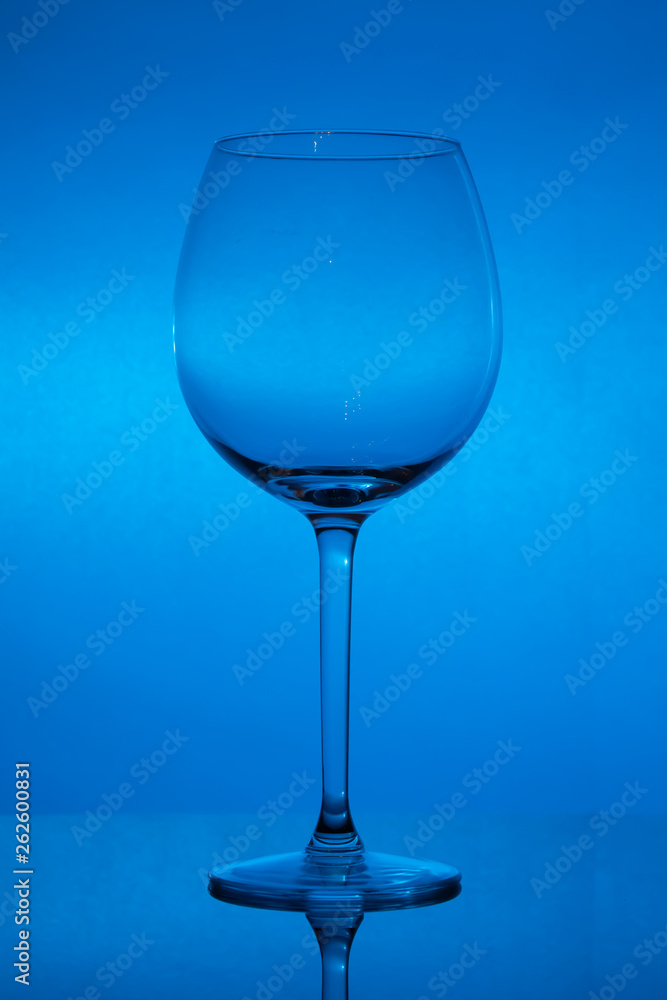Empty wine glass on blue background, empty wineglass Empty wine glass on blue background, empty wineglass