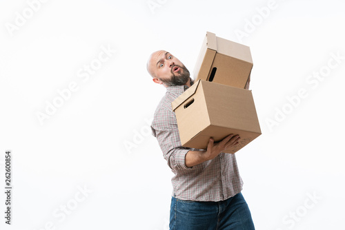 Portrait of a handsome young man holding card boxes, isolated on white © sutulastock