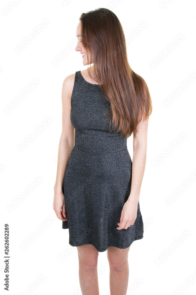 Side view of pretty slim woman in grey dress with long brown hair Side view of pretty slim woman in grey dress with long brown hair