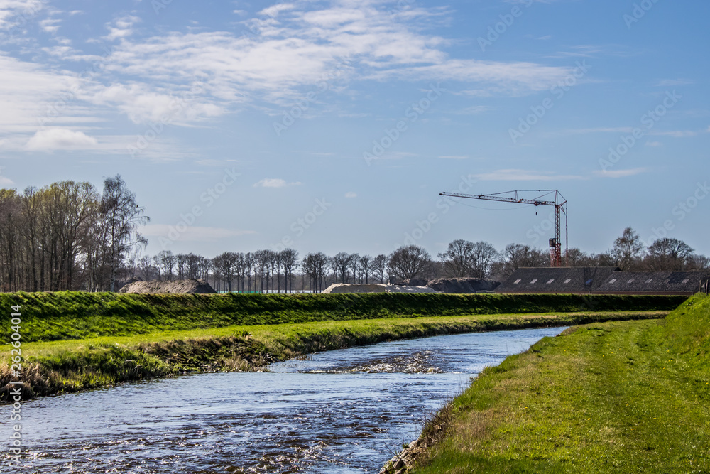 Building Crane near a river in Spring