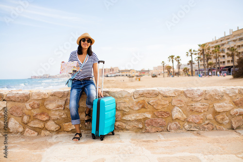 young indian woman sitting in front of the sea