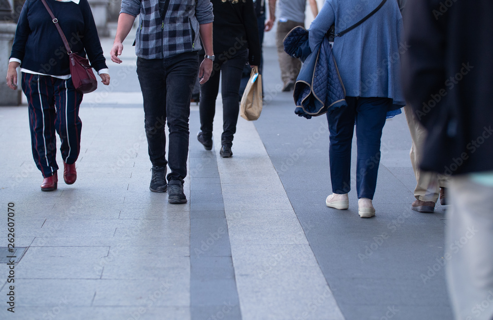 People and tourists walking on sidewalks People and tourists walking on sidewalks