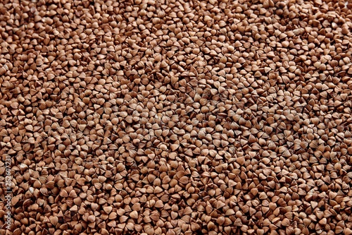 Textured background of natural buckwheat spread out on the table