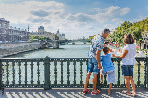 Happy family of three enjoying vacation in Paris, France © Max Topchii