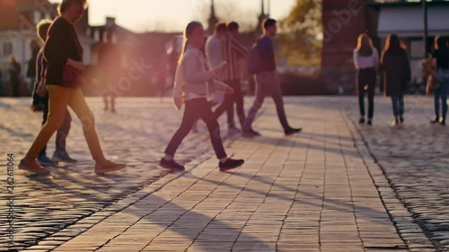 Unrecognizable people walking on the streets of Warsaw's Old Town.