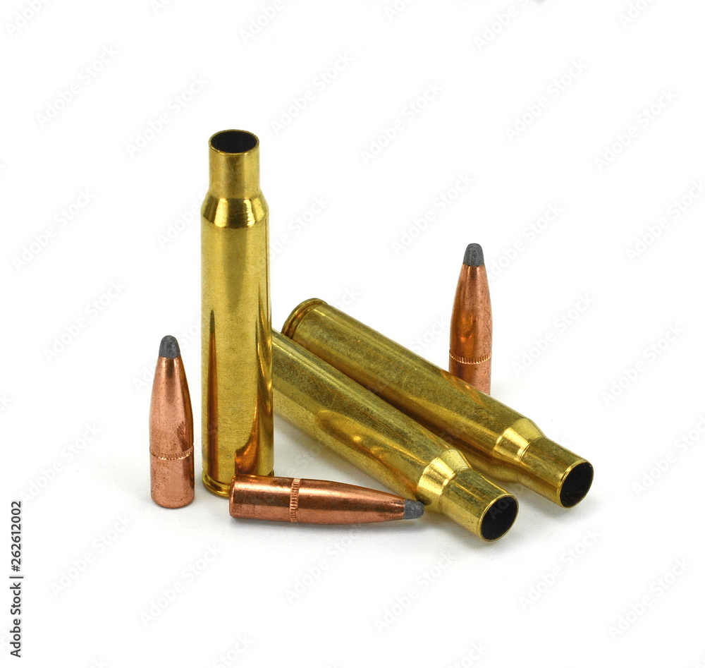 A rifle bullet, empty shell on white background. A rifle bullet, empty shell on white background.