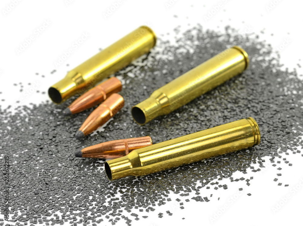 A rifle bullet with gun powder isolated on white. Stock Photo