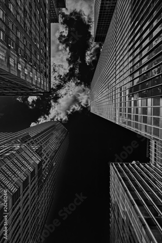 Low view on skyscrapers in Manhattan in black and white with clouds.