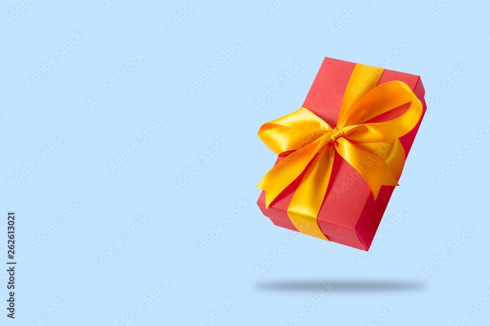 Flying gift box on a light blue background. Holiday concept, gift, sale, wedding and birthday. Flying gift box on a light blue background. Holiday concept, gift, sale, wedding and birthday.