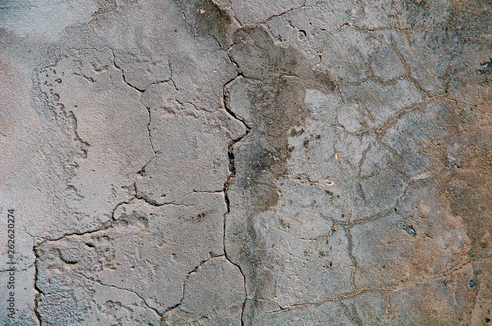 Fototapeta premium Gray concrete textures background. Cracks. Scratches. Damage. Cracked stone wall background