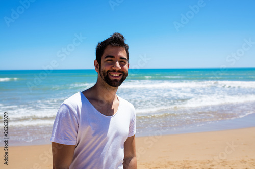 young man happy on the beach