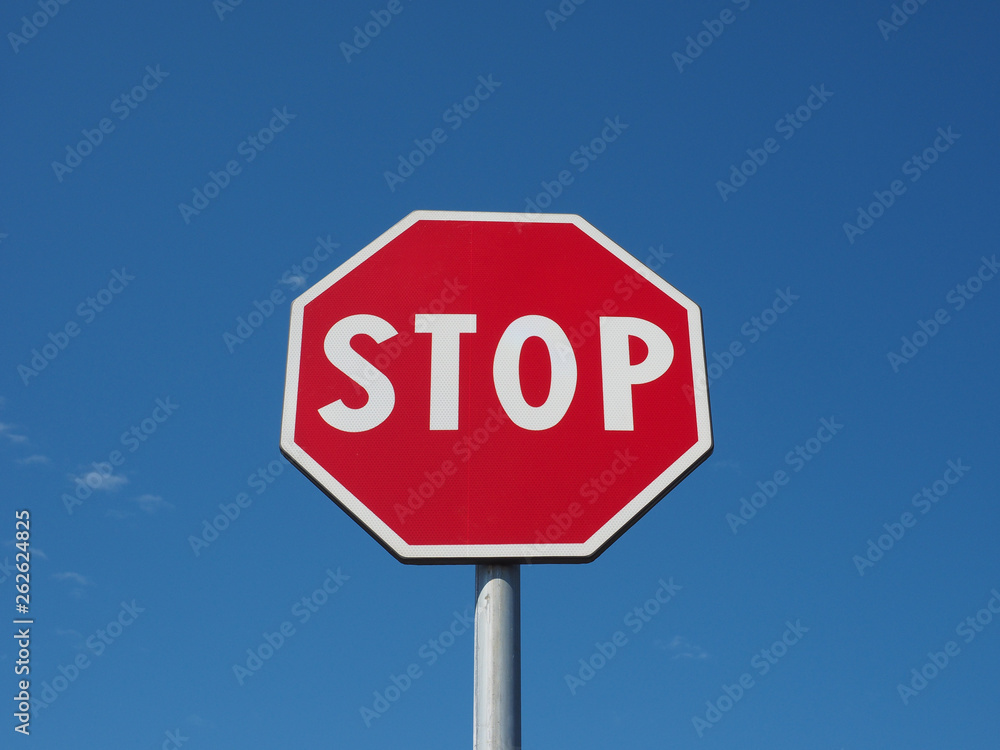 stop sign over blue sky