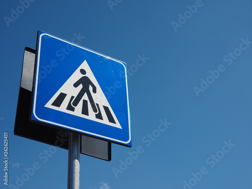 zebra crossing sign over blue sky
