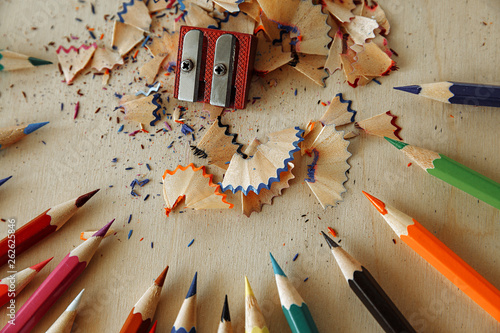 Image of colored pencils on a wooden background