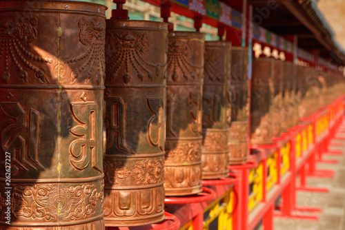 Row of mani praying wheels of Putuo Zongcheng Buddhist temple, one of the Eight Outlying temples in Chengde, Heibei, China. Unesco World Heritage Site.