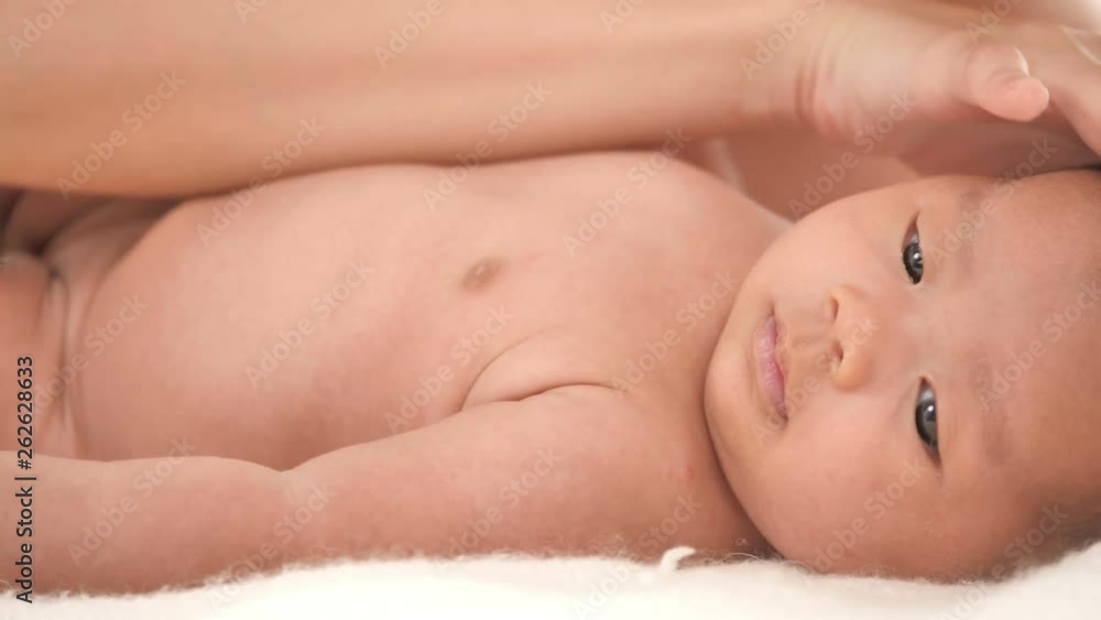 Beautiful young asian mother with her newborn baby in bed at home Beautiful young asian mother with her newborn baby in bed at home
