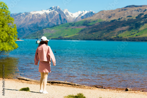 The girl on the background of the lake and the mountain landscape in Southern Alps, New Zealand. With selective focus. © ggfoto