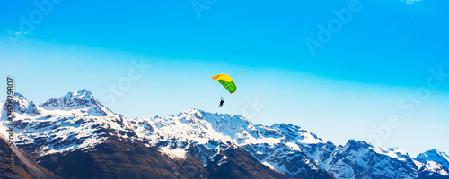 Parachutist on the background of a mountain landscape, Southern Alps, New Zealand. Copy space for text.