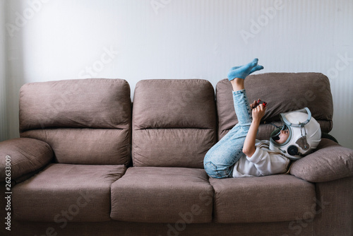 Obraz na plátně Adorable little girl sitting on couch
