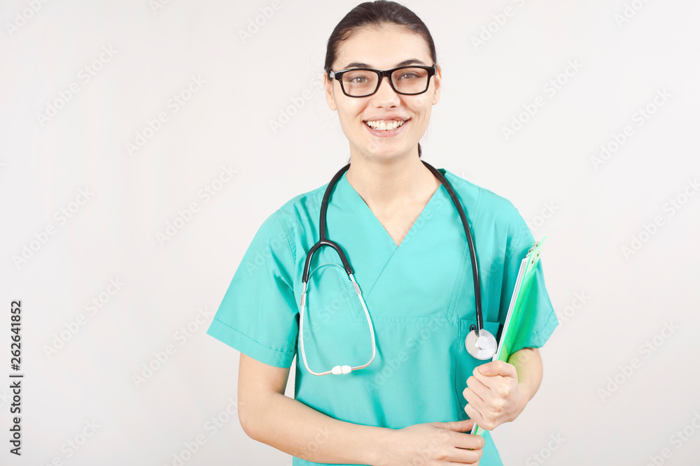 Young woman doctor portrait on gray background.