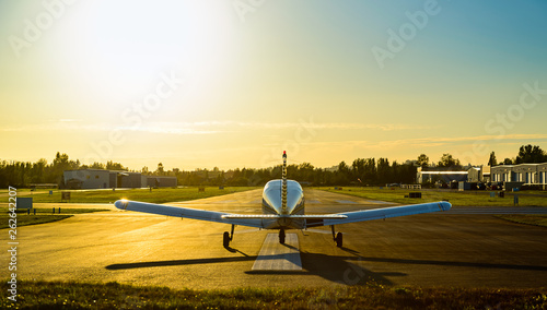 Small plane ready to take off at sunrise. photo