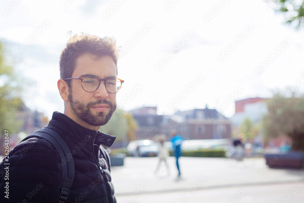 Young man smiling in the city Young man smiling in the city