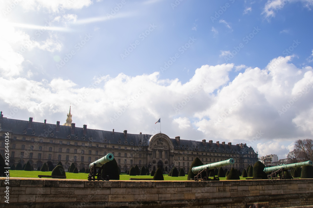 View of the old bronze cannons on the background of the Palace and the blue sky with clouds