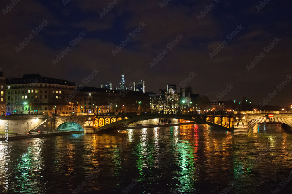 Night city view of the river Seine and bridges in Paris