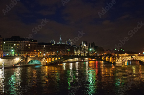 Night city view of the river Seine and bridges in Paris