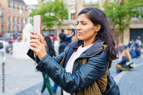 Photography Young indian woman taking photo in the city