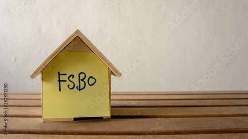 House or home model with text FSBO (For Sale by Owner). Property or real estate co