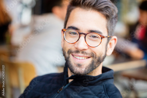 young man smiling in the city