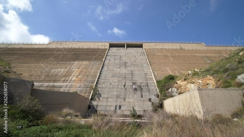 Wallpaper Mural Girl walks across the step of a big dry dam on a sunny day slow motion wide angle, Greek Island, Serifos Torontodigital.ca