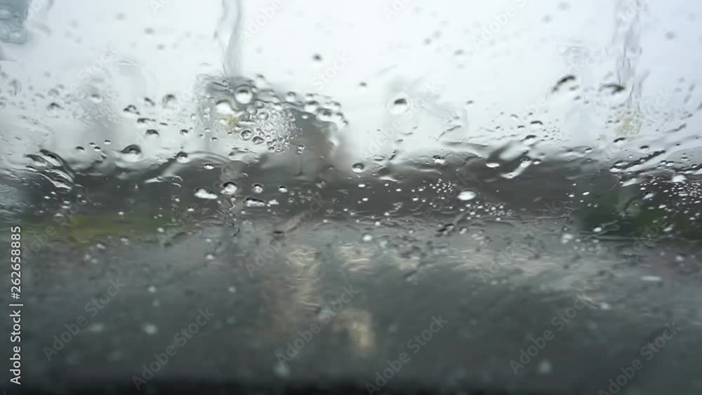 Heavy rain, hale, hail on the windscreen making visibility poor and driving conditions dangerous and un predictable Heavy rain, hale, hail on the windscreen making visibility poor and driving conditions dangerous and un predictable