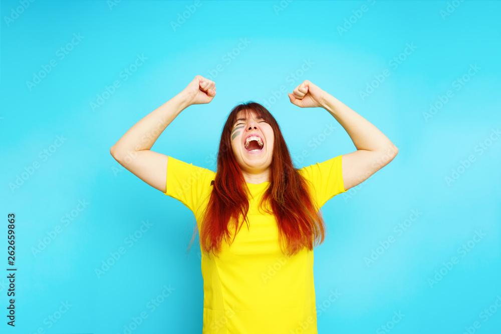 Woman is socccer fan in yellow t-shirt Woman is socccer fan in yellow t-shirt