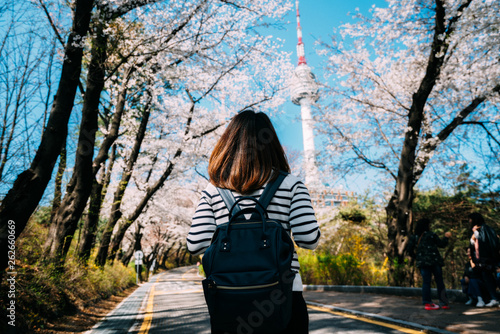 Young woman traveler backpacker traveling into N Seoul Tower at Namsan Mountain in Seoul City, South Korea photo